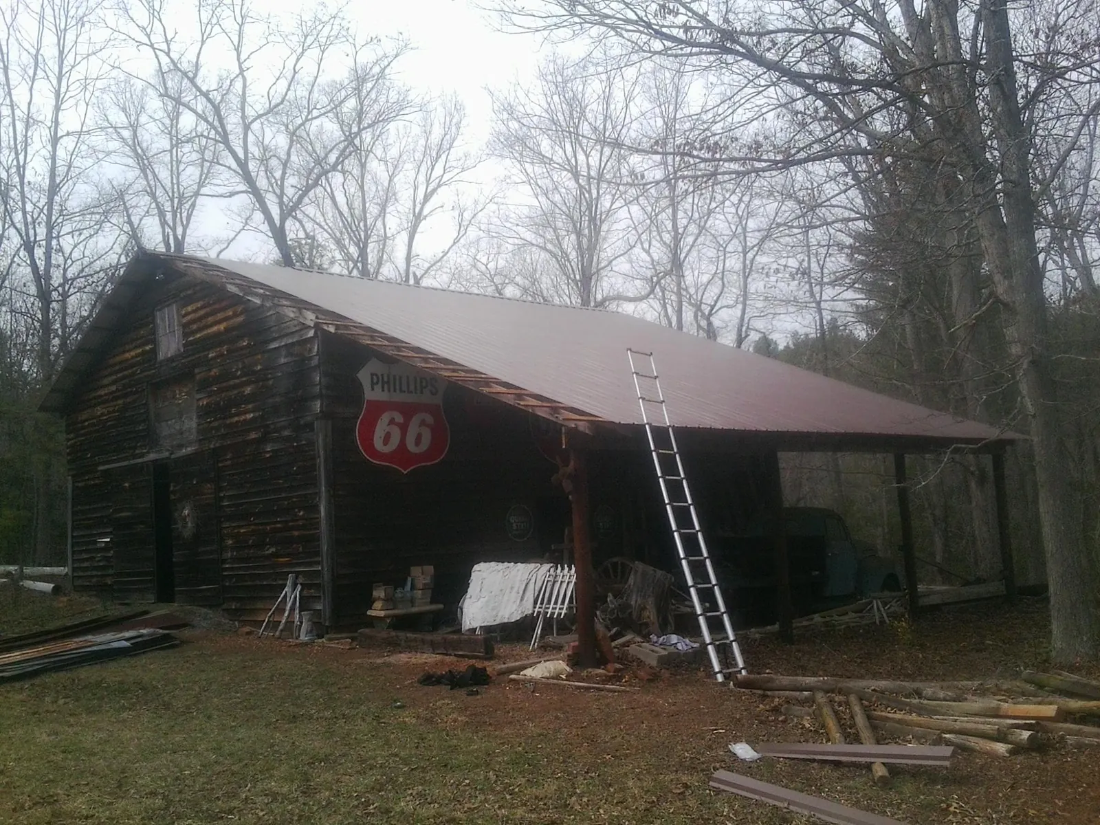 New metal roof on an open sided timber barn with a vintage sign in Garnet Valley