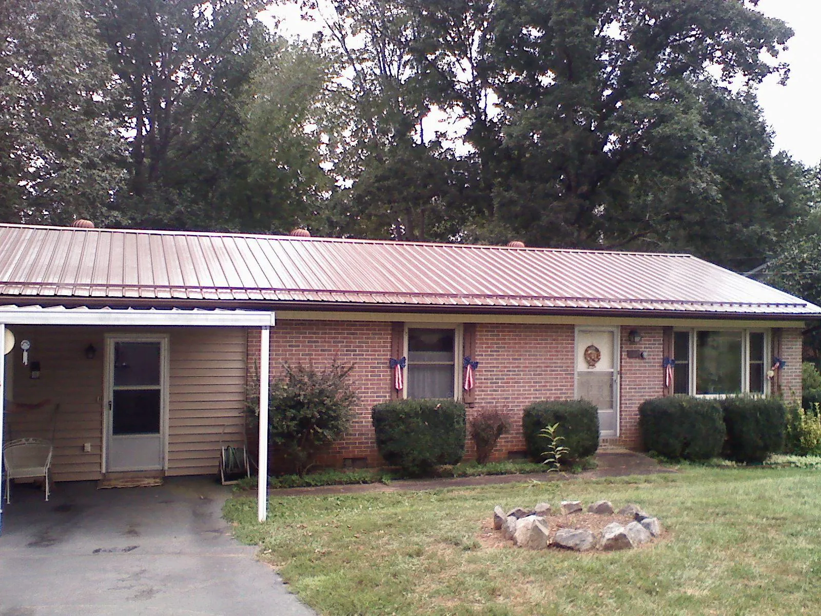 Bronze metal roof and carport on a brick ranch home — Roof Repair work by our crew in Garnet Valley